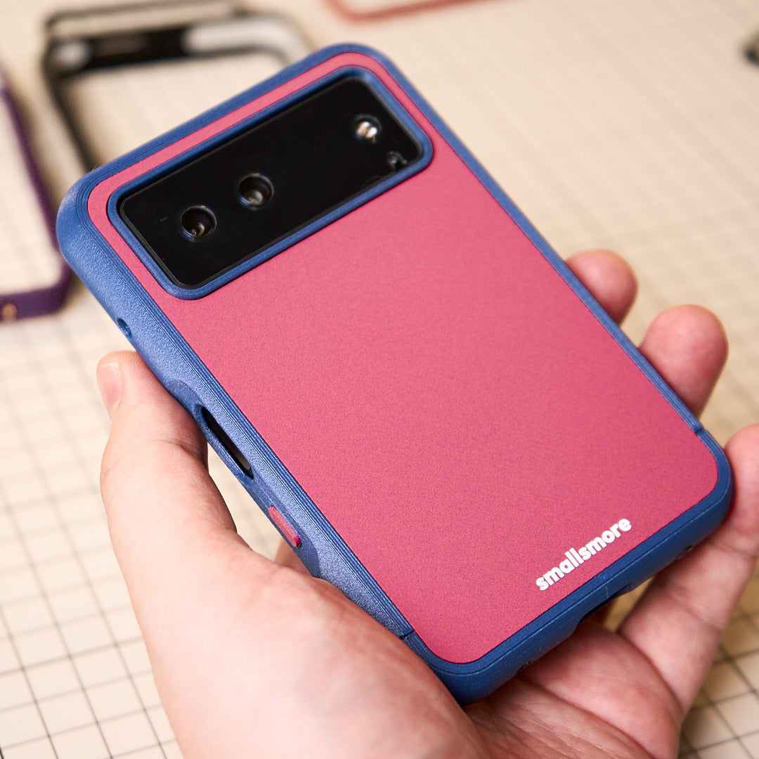 Blue frame and pink backplate held in hand