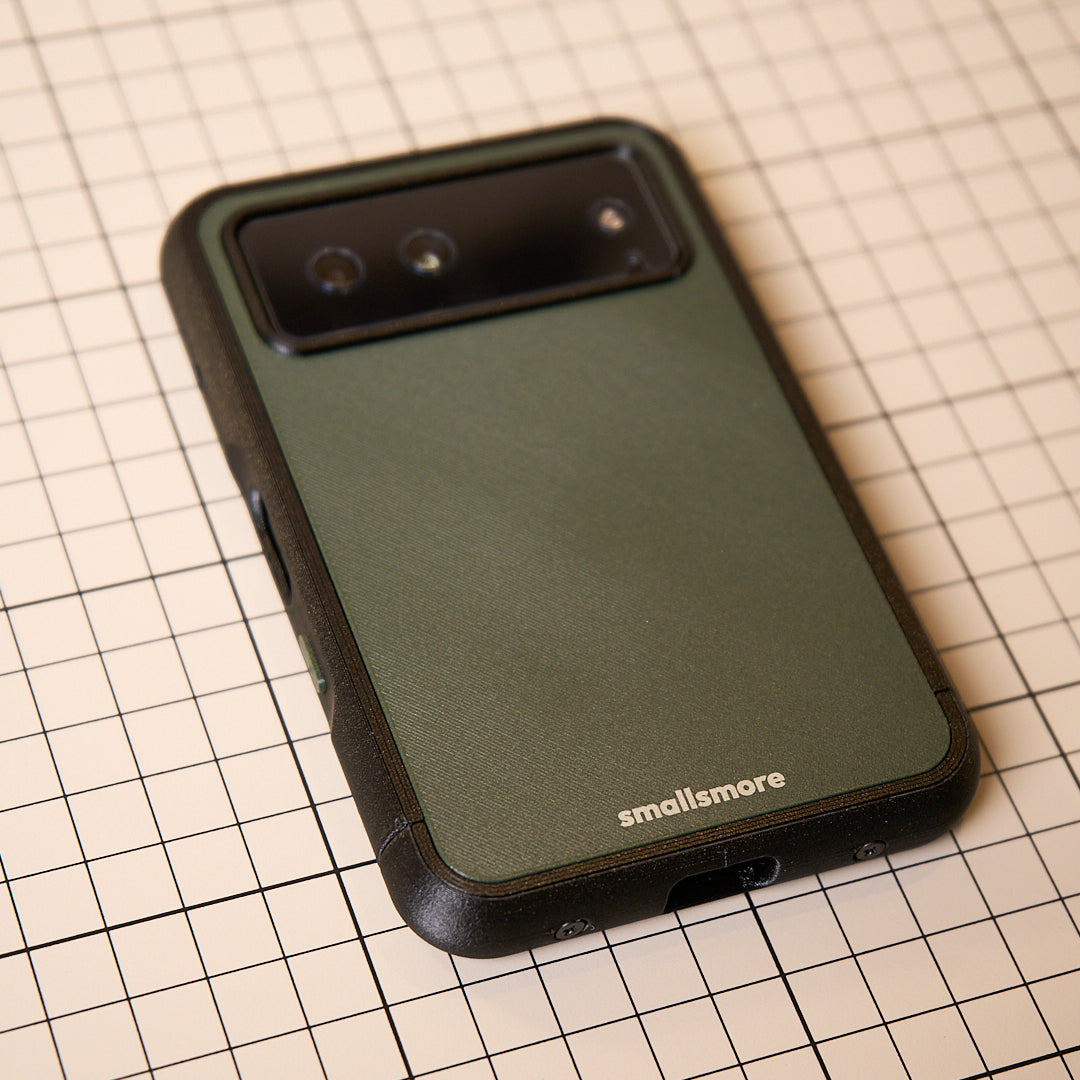 Olive backplate and black frame held in hand