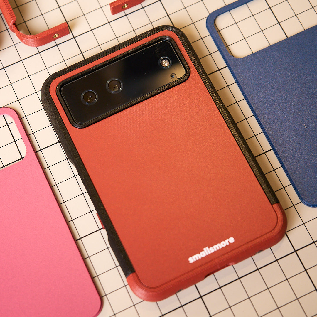 Red frame and backplate with a black camera frame on a workbench