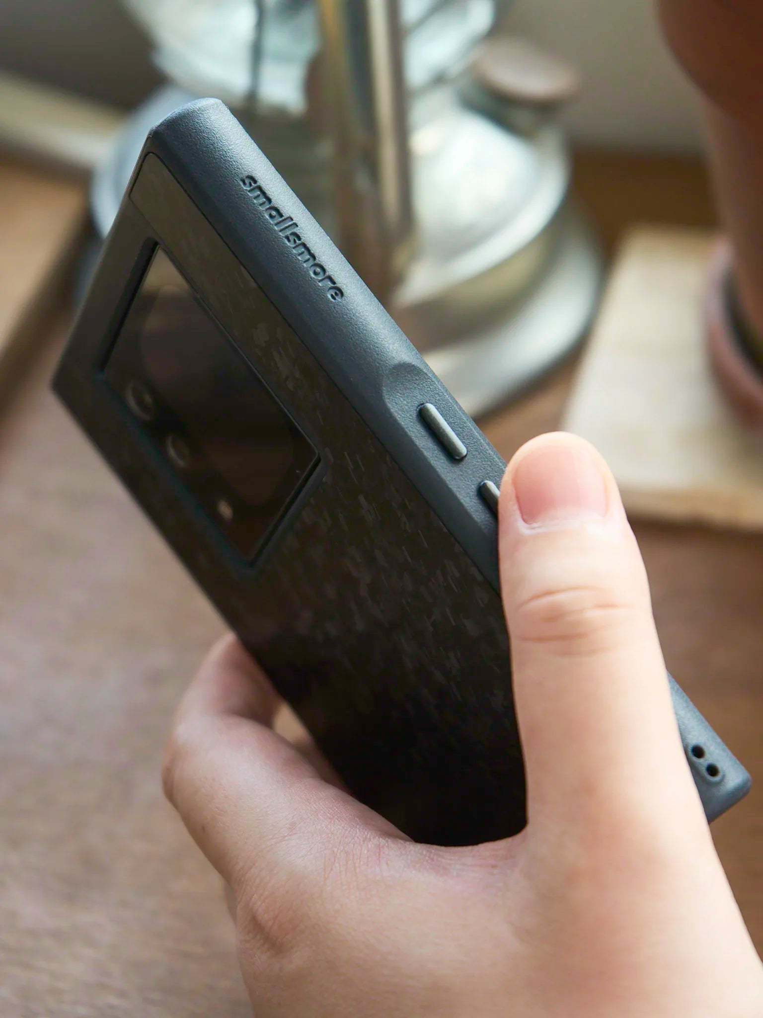 Side view of OCase XUAN with smallsmore logo and metal buttons