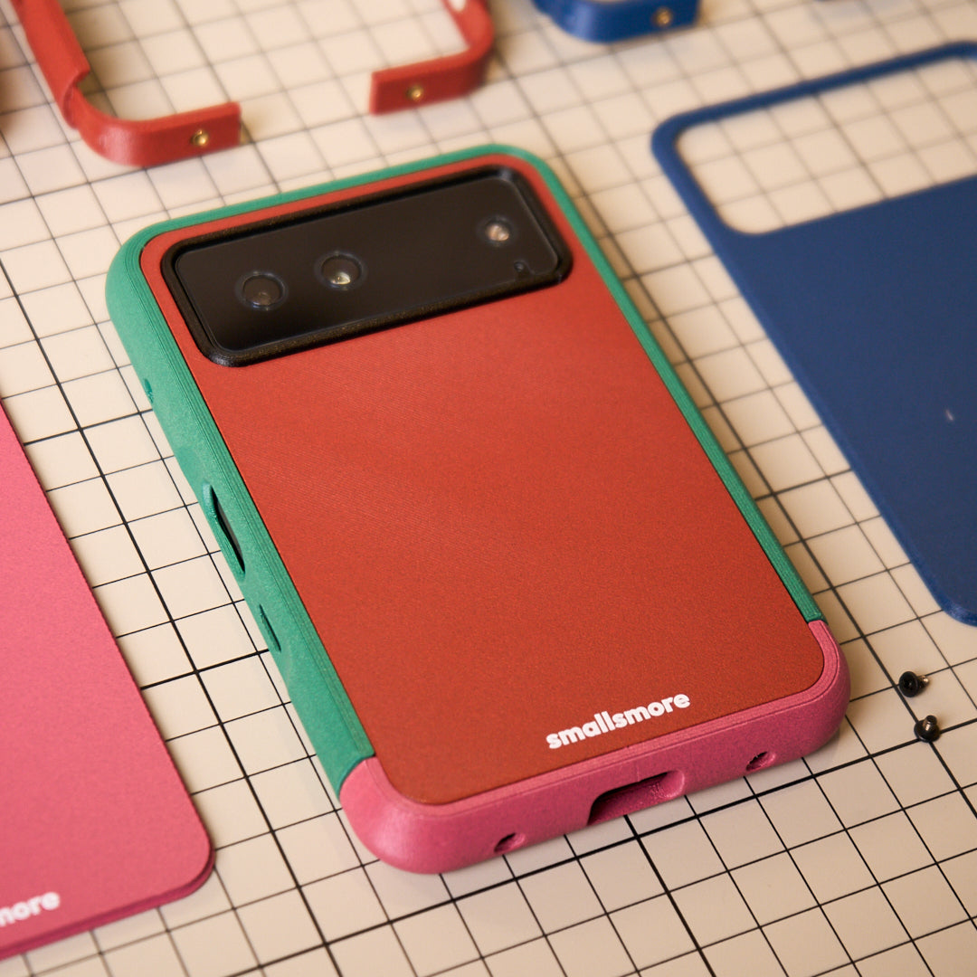 Green frame, red backplate and pink chin on a workbench