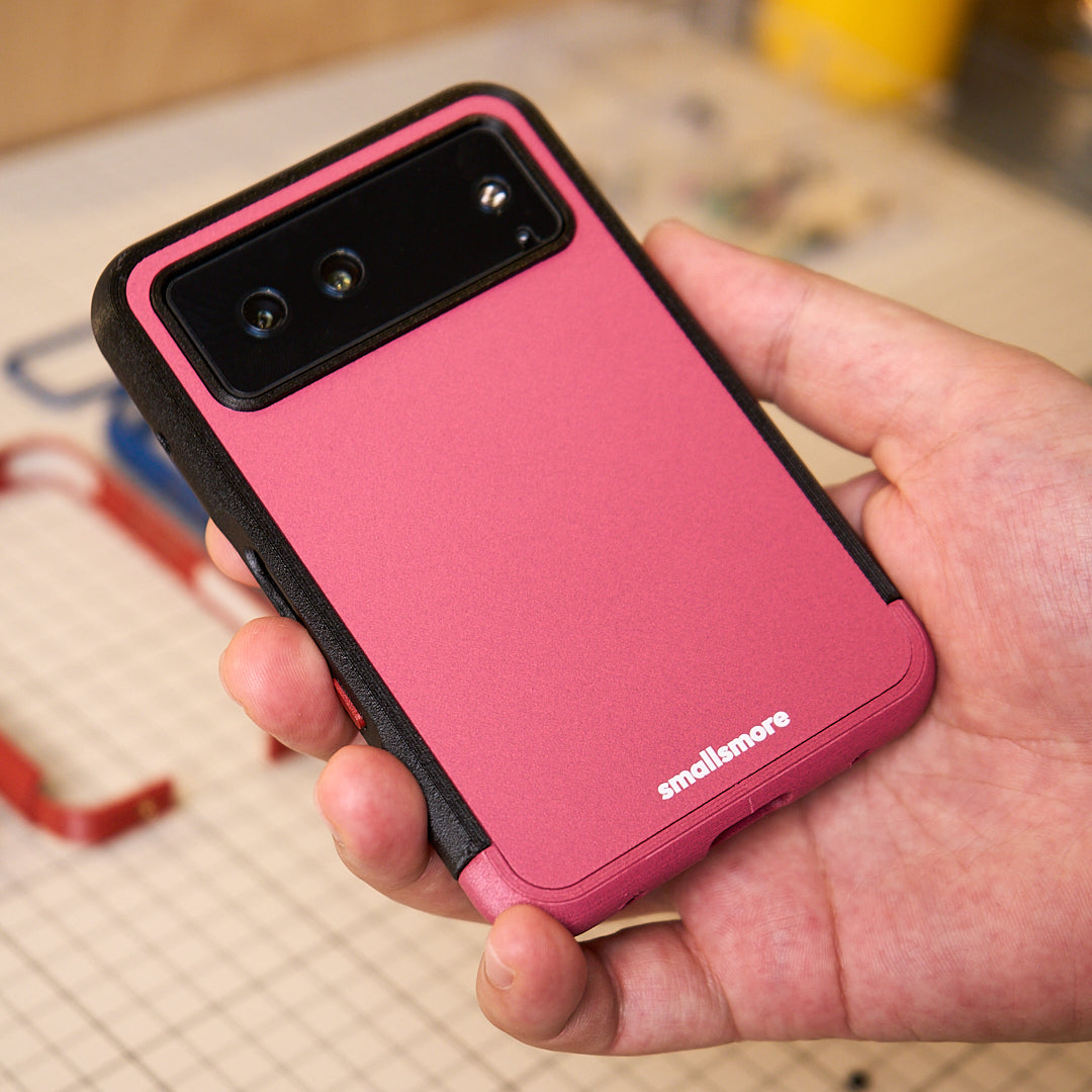 Pink backplate and black frame held in hand