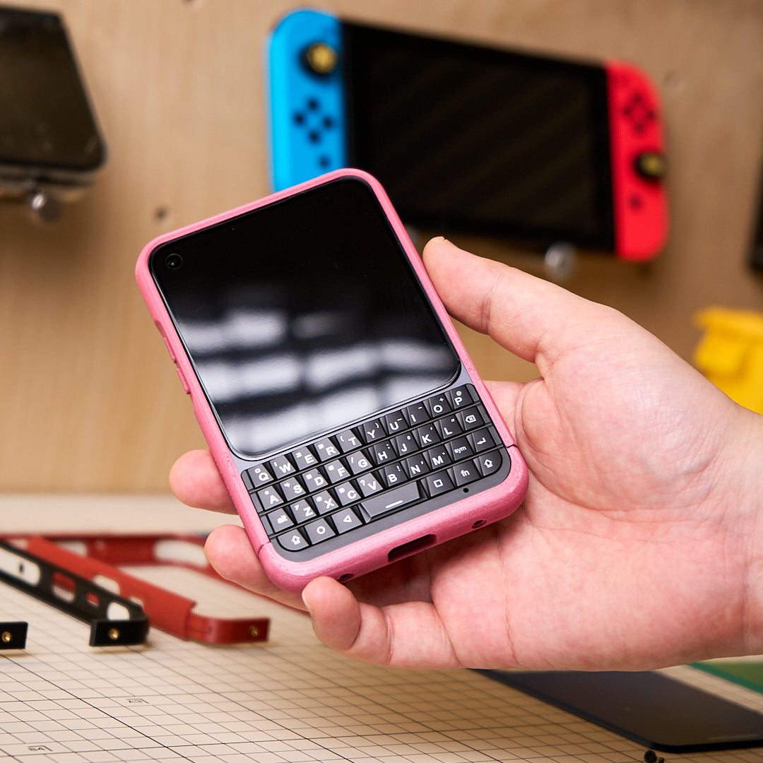 Front of a pink MCase held beside a game console